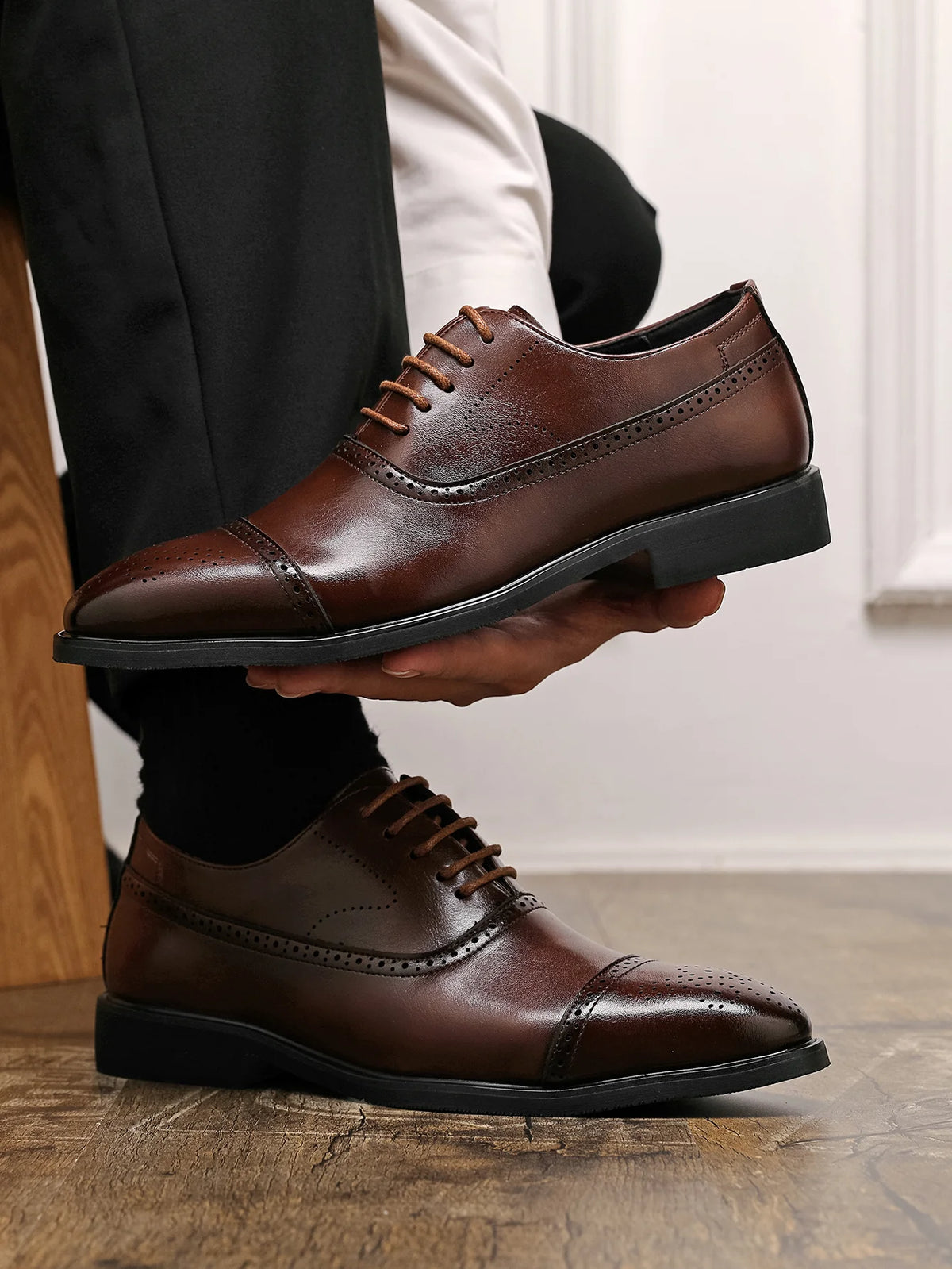 Sapato masculino oxford marrom sendo segurado — Terno Lux